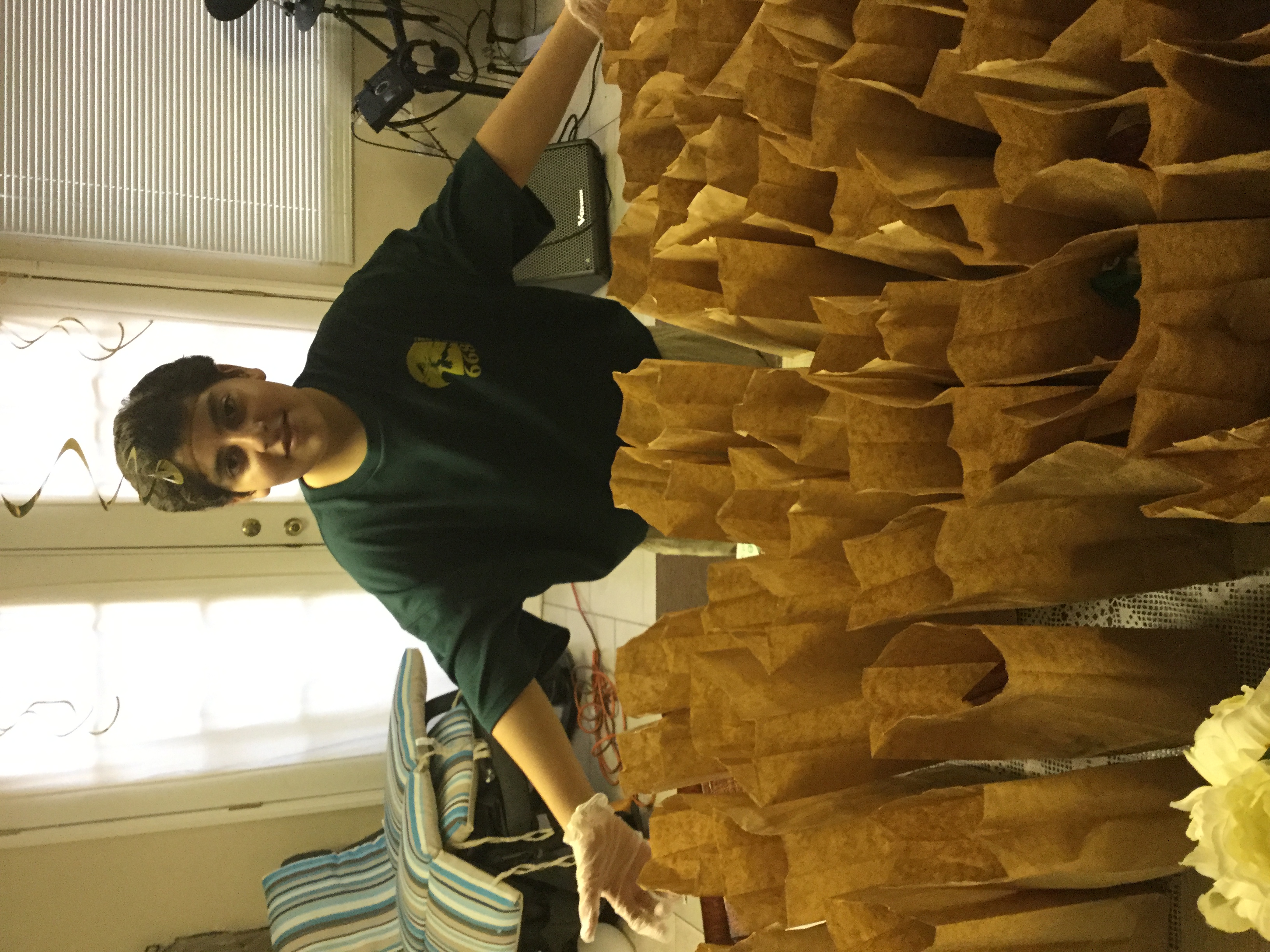 Scout preparing sack lunches for Interfaith as part of Community Service